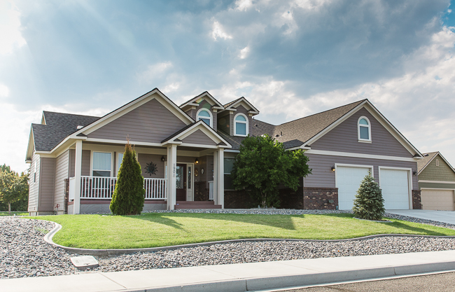 BUYER PROMISE Charming family home in Boise, ID with a modern facade and spacious garage.